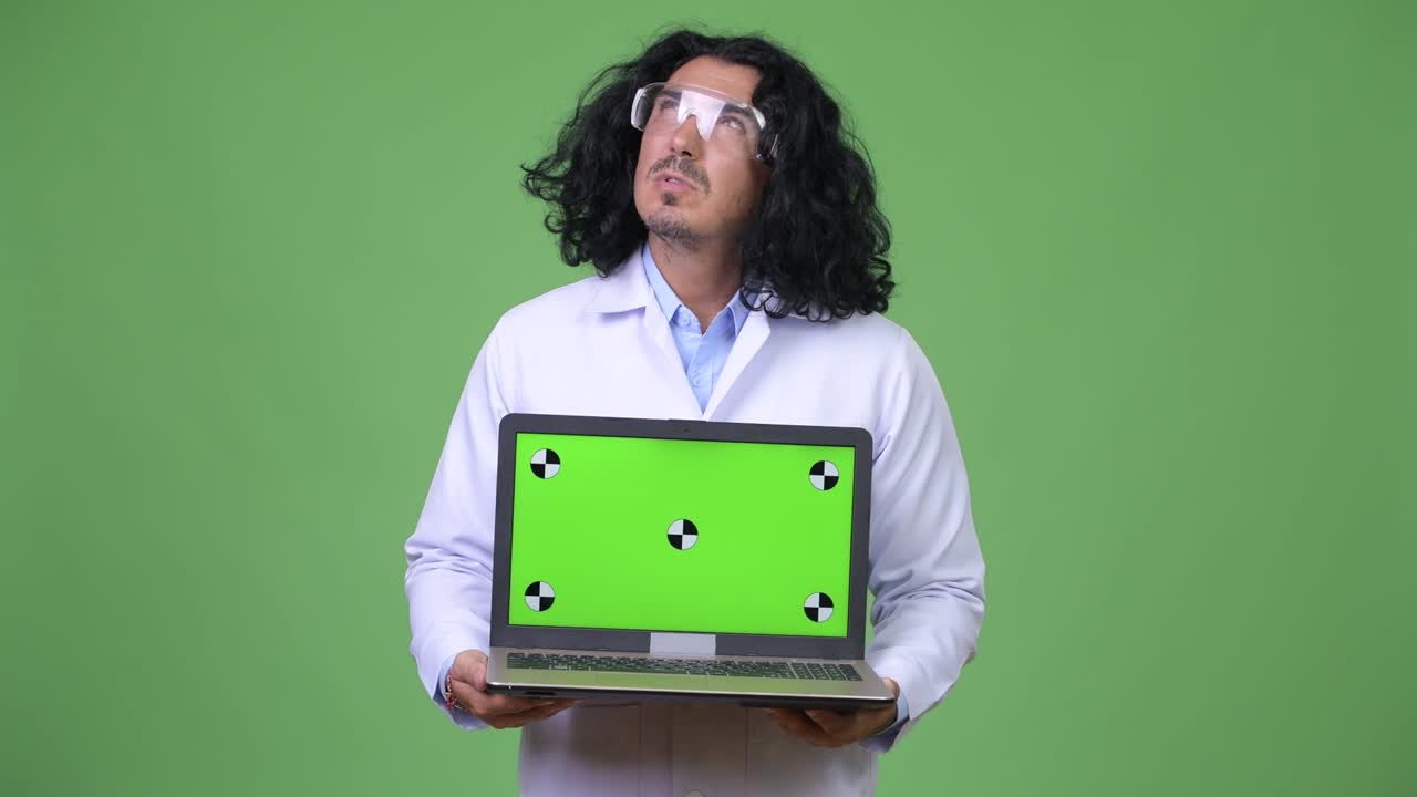 Handsome man scientist thinking while showing laptop