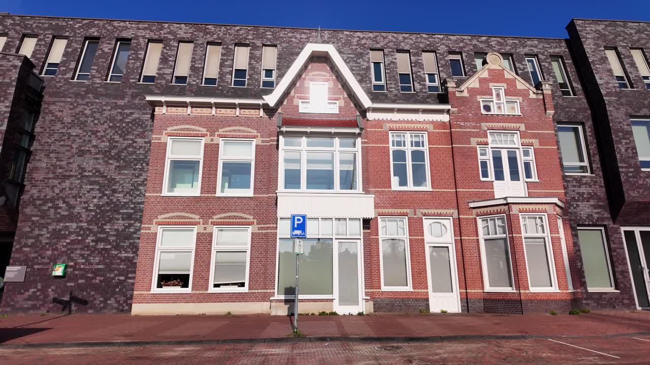 Detailed view of historic red brick facade with decorative windows and gables, part of Coevorden’s modernized cityscape. Location: Coevorden, Netherlands Coevorden, Nederland