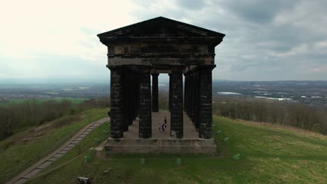 aerial zoom out cinematic rotating shot of penshaw monument at north east, uk in a cloudy evening