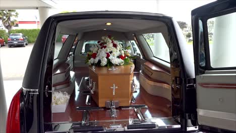 closeup shot of a funeral casket in a hearse or chapel or burial at cemetery