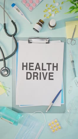 VERTICAL VIDEO OF HEALTH DRIVE WRITTEN ON MEDICAL PAPER