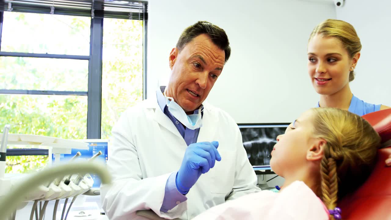 Dentist interacting with young patient