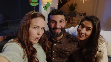 POV-Shot-Of-Friends-Dressing-Up-With-Irish-Novelties-And-Props-At-Home-Or-In-Bar-Posing-For-Selfie-Celebrating-At-St-Patrick's-Day-Party-1