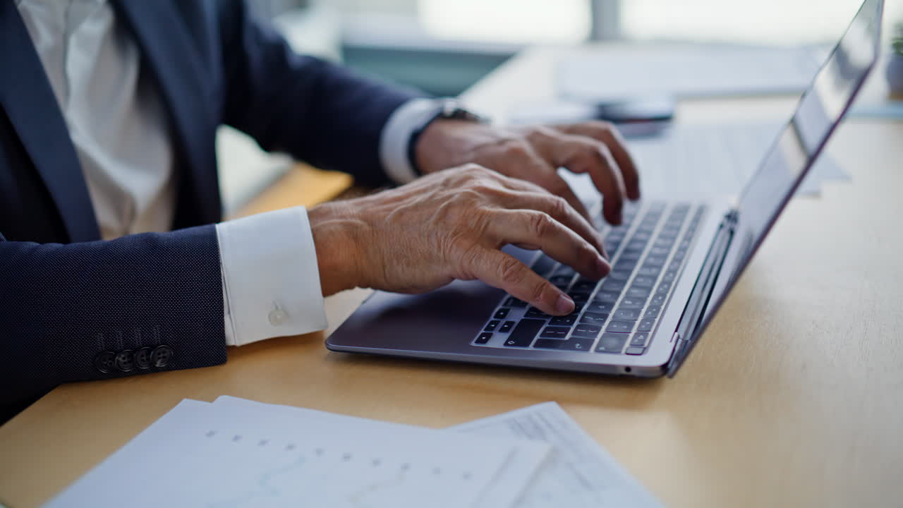 Smiling employee typing computer making online research in office closeup