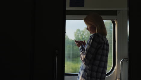A-Young-Traveler-Uses-A-Smartphone-In-The-Train-Car