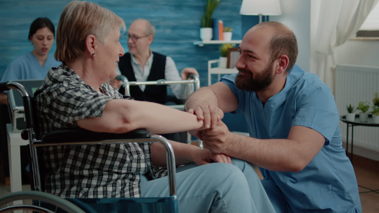 Man nurse comforting retired woman with disability
