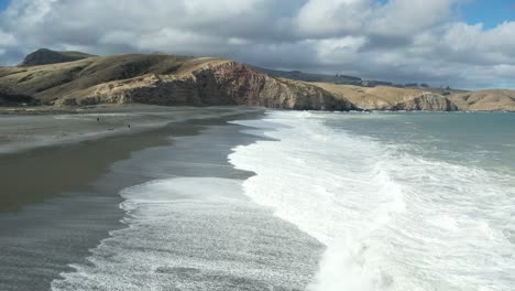 Low-aerial-towards-Banks-Peninsula---turbulent-white-water-at-Birdlings-Flat-Beach