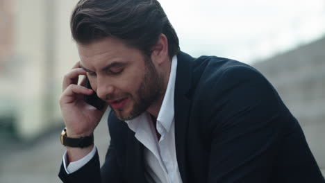 businessman having conversation on smartphone. man talking on mobile phone