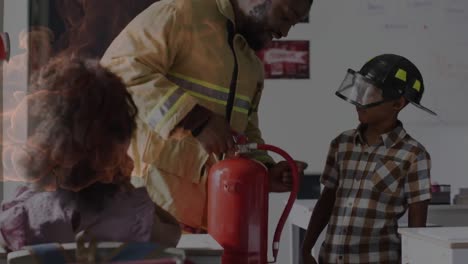 animation of fire over african american fireman demonstrating fire extinguisher to pupils