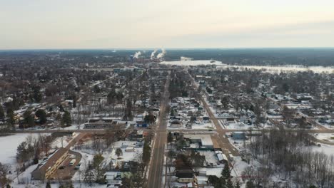 aerial, empty main street of a small rural suburban town in the united states during winter