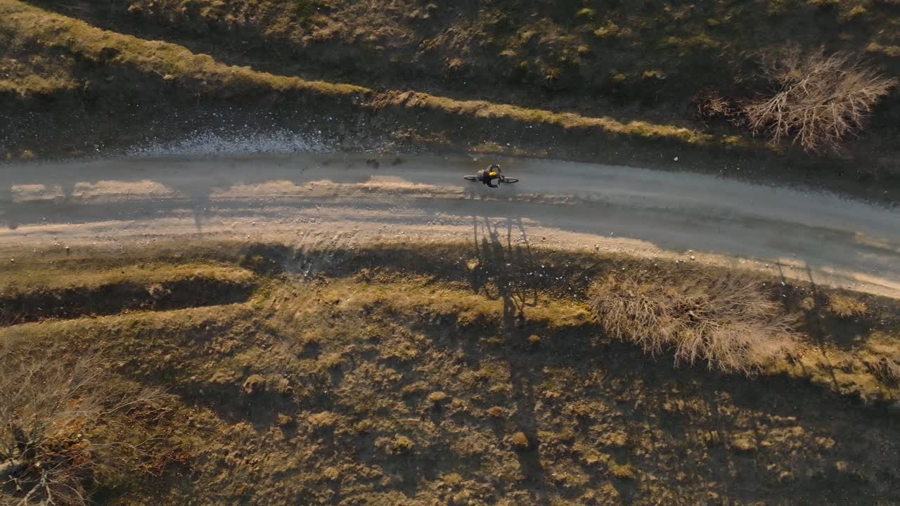 Aerial View of a Cyclist Riding on a Rural Dirt Road