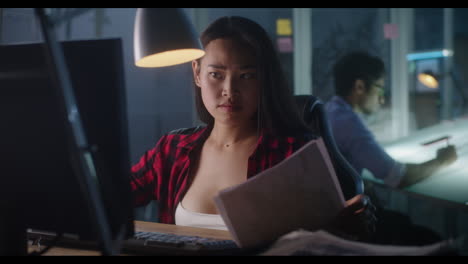 woman working late on computer in design office