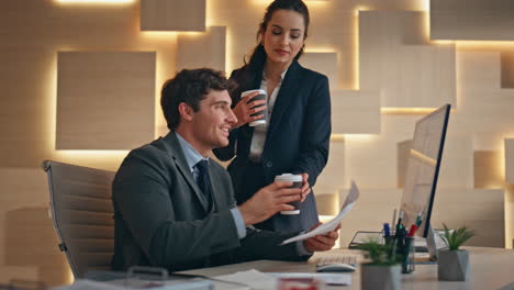 focused man analyzing documents at computer closeup. secretary bringing coffee