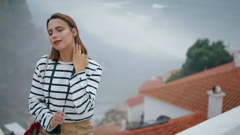 relaxed girl posing vacation trip at sea town view. beautiful millennial enjoy