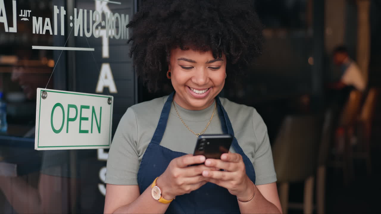 Happy Woman Checking Phone in Cafe