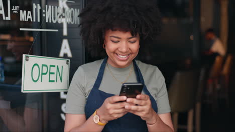 happy woman checking phone in cafe