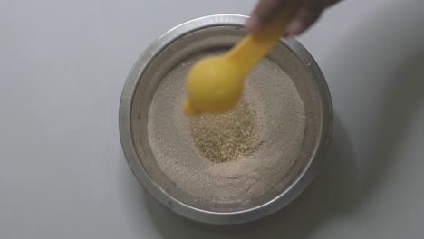 adding one teaspoon of sugar to the yeast and warm water mixture in a small bowl