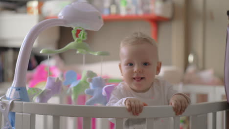 Cute-baby-girl-playing-in-a-round-crib-5