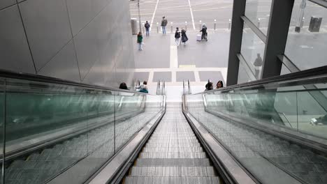 people descending an escalator in melbourne