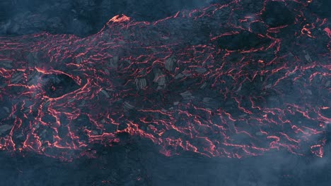 above lava field flowing on earths crust with top layer solidifying and cracked