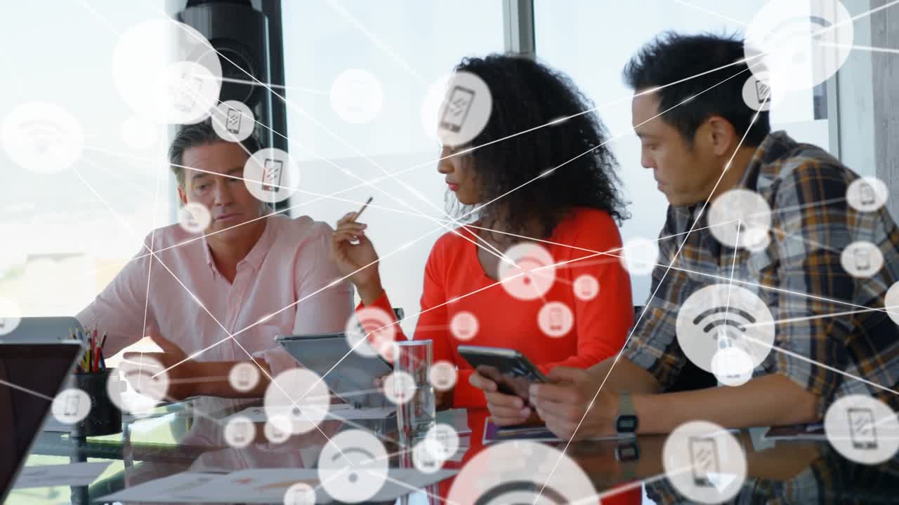 Phone and wi-fi icons connecting with lines over diverse coworkers discussing and using technology