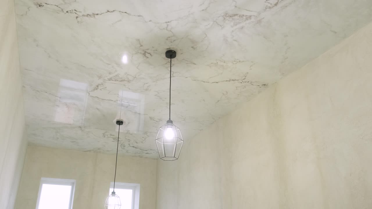 Installation of stretch ceilings with a print repeating marble
