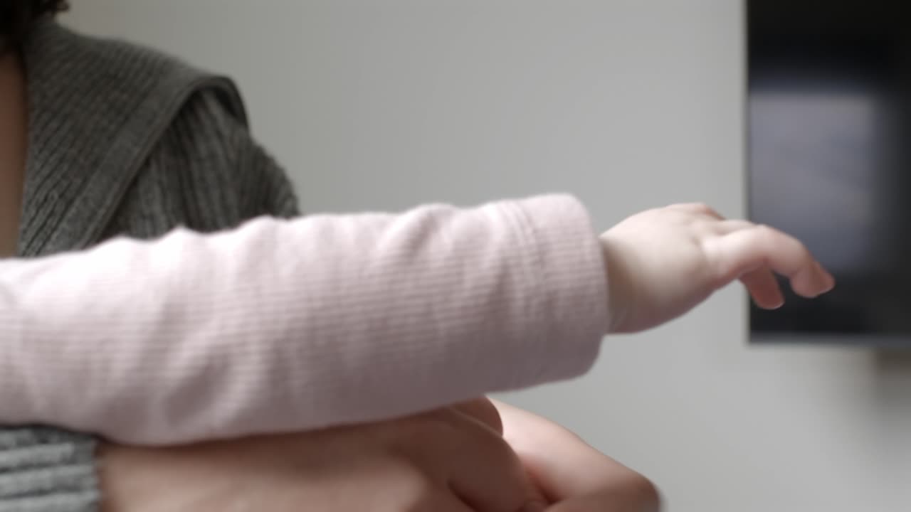 Baby Holding Her Mother's Hand. - closeup shot