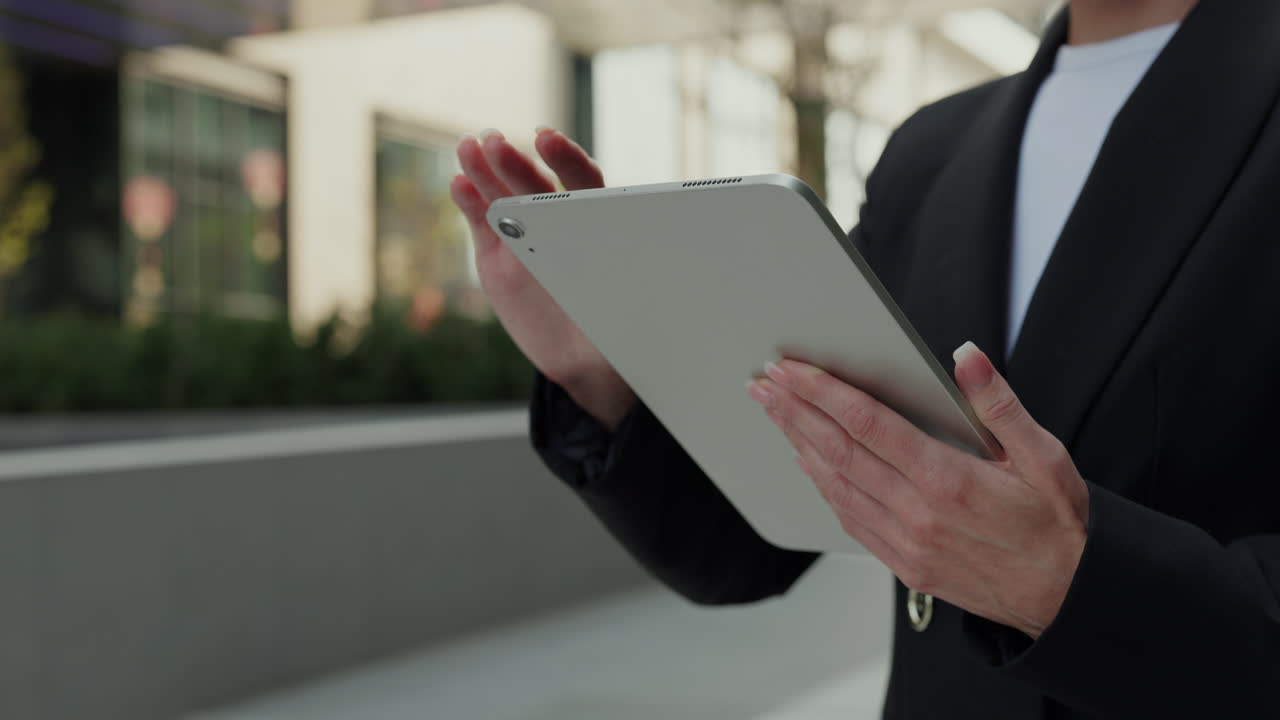 야외에서 태블릿을 사용하는 여성