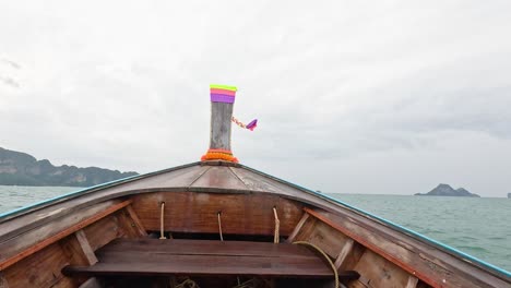 boat travels through ocean towards distant islands