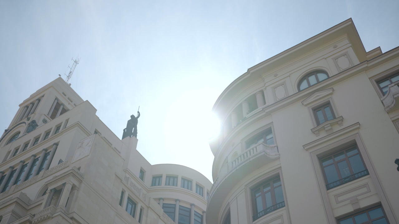 Bright Sunburst Over Civic Building And Statue Against Azure Sky, Smooth Tilt Revealing Curved Roofline