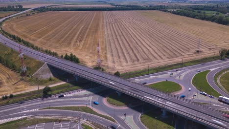drone hyperlapse video of fast-moving cars on the e574 road, with an open agricultural area near brașov
