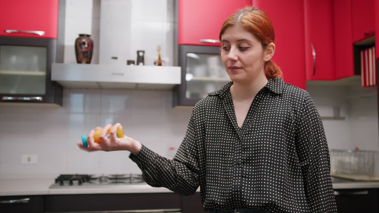 Woman Shakes Orange Juice In Kitchen Before Snack