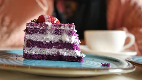 purple cake with whipped cream and strawberry