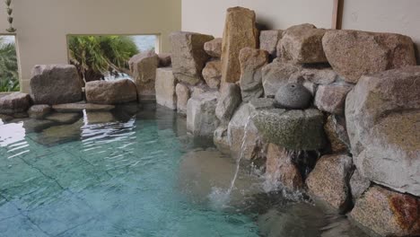 japanese rotenburo bath, hot spring water flowing out of rocks on seaside