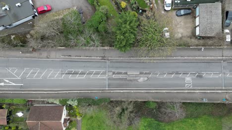 Vehicles-avoiding-a-large-pothole-UK-highway-overhead-birds-eye-view-drone-aerial