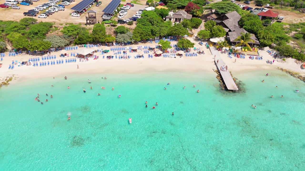 Bird's eye view of tourists enjoying beautiful Caribbean waters of Curacao at Playa Porto Mari