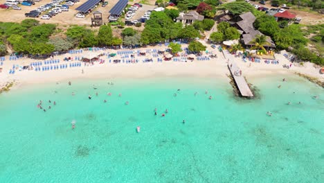 Bird's-eye-view-of-tourists-enjoying-beautiful-Caribbean-waters-of-Curacao-at-Playa-Porto-Mari