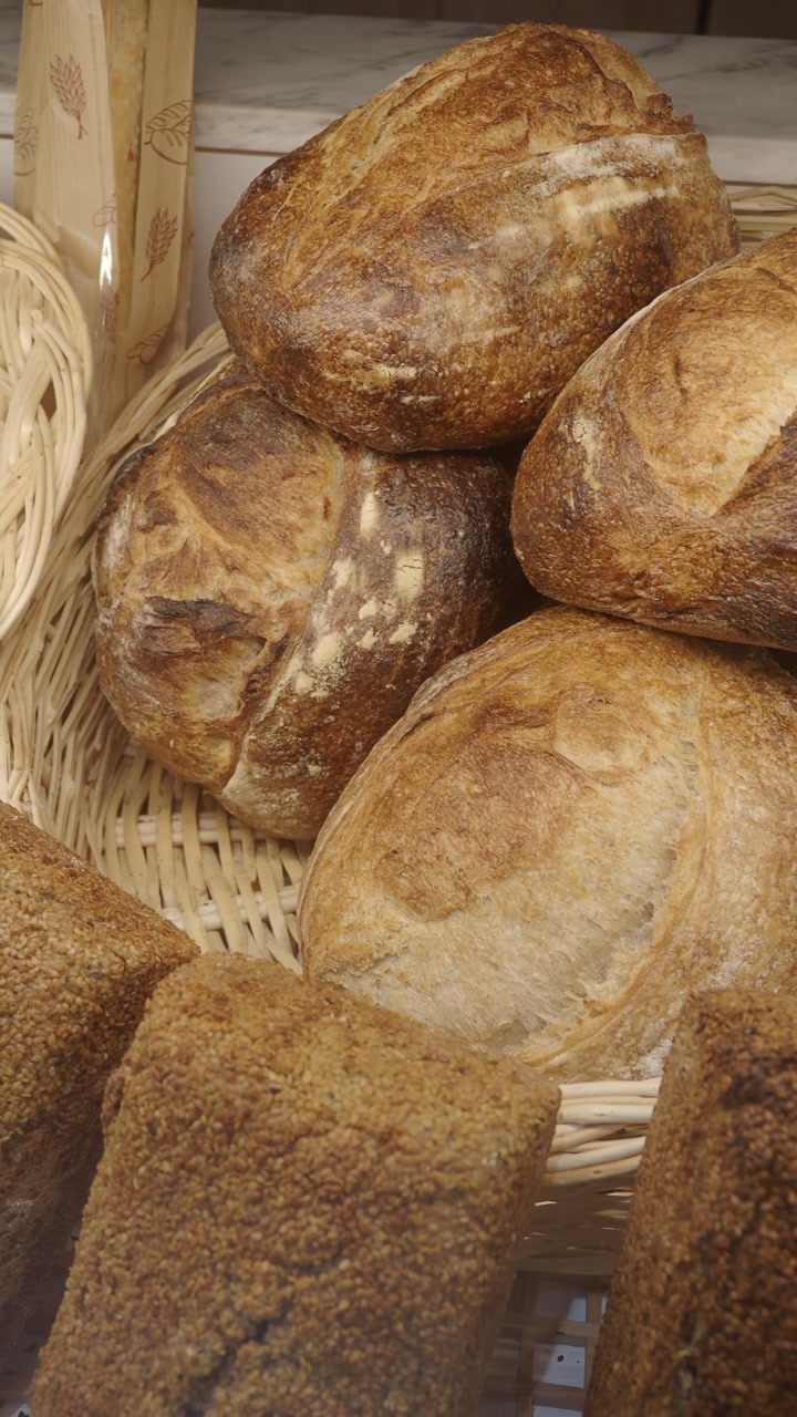 Close-up of Fresh Artisan Bread Loaves in Wicker Baskets