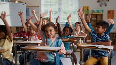 Enthusiastic Young Students Raising Hands in a Classroom