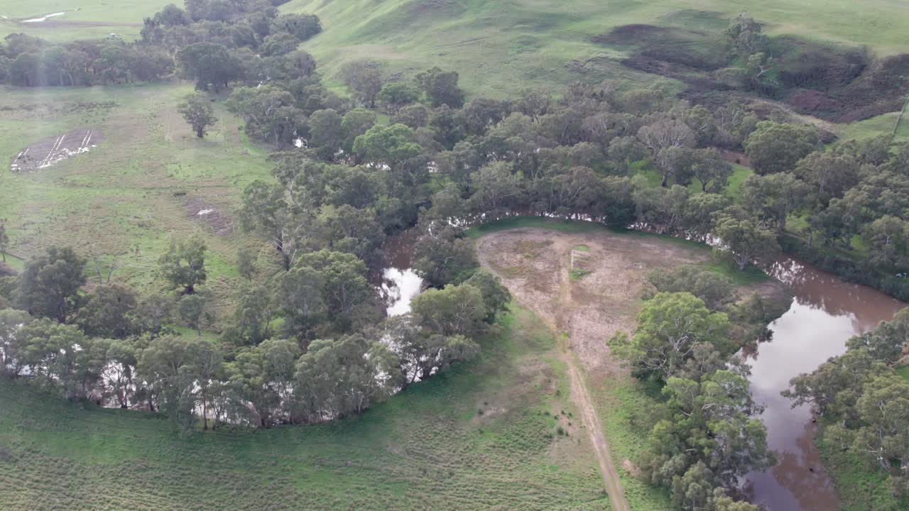 Sideways aerial view of the junction of the Glenelg and Wannon Rivers, south of Casterton, western Victoria, Australia. June 2023.
