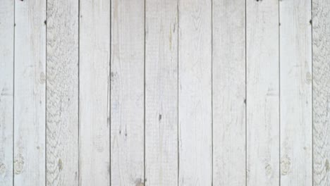 pale of vintage retro hardcover books appear in two lines on wooden table. flat lay stop motion