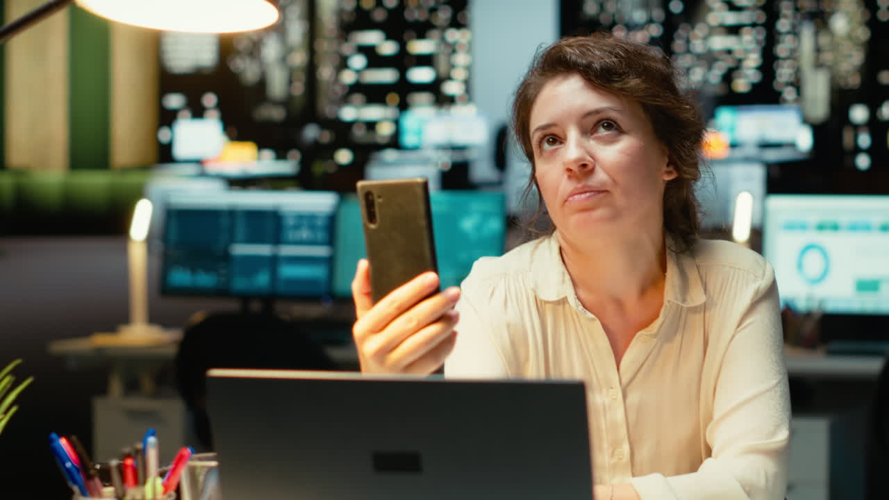 Vertical Video Entrepreneur joining online meeting on phone at night in office