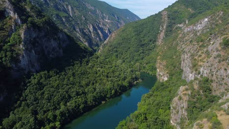 flying through incredible matka canyon with river treska in valley of mountains with lush green trees - macedonia (near skopje)