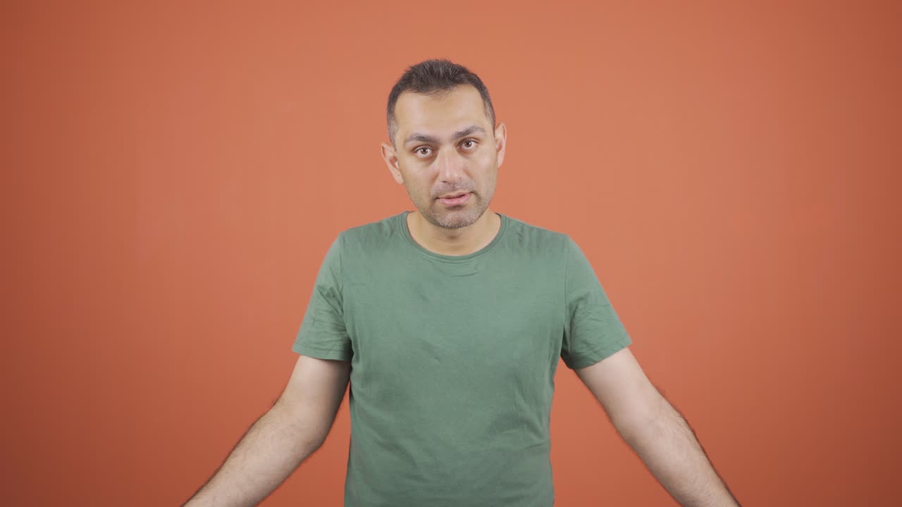 Businessman saying shut up to the camera.