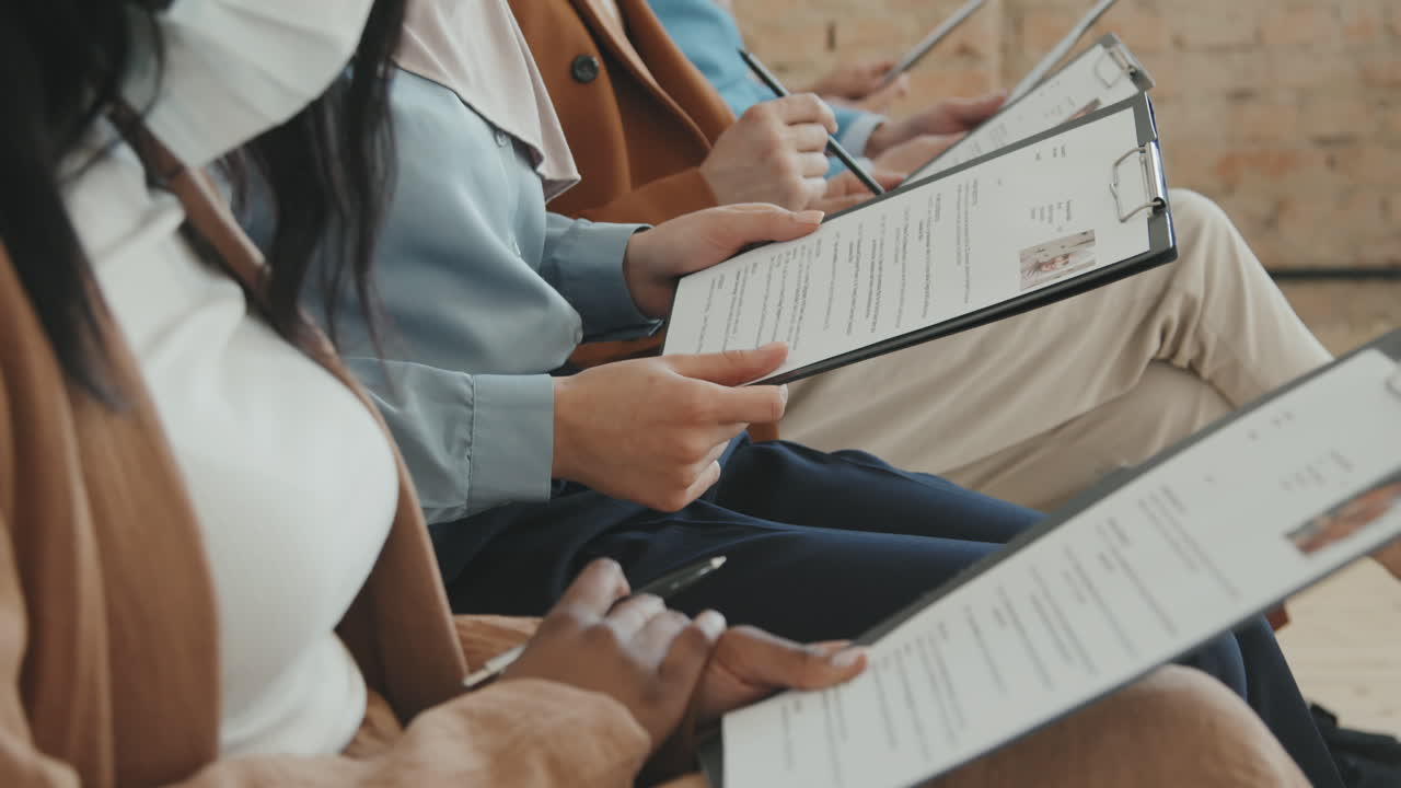 People Looking at Job Application Forms