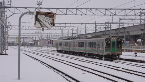 snow covering morioka railway station and jr train in northern japan