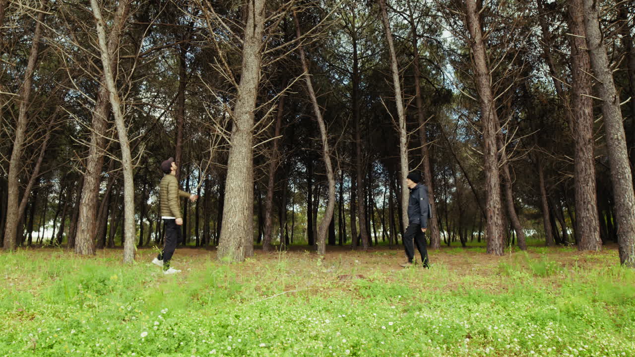 Elderly Father and Son Walk in the Woods During the Fretime