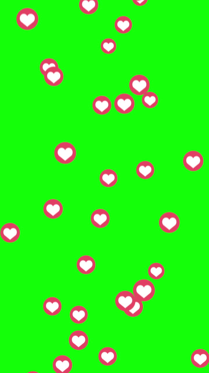 Flying red small circle icons with heart for social networks on a green background. Loop animation. Like sign. Vertical video.