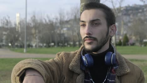 young man waiting friends at park