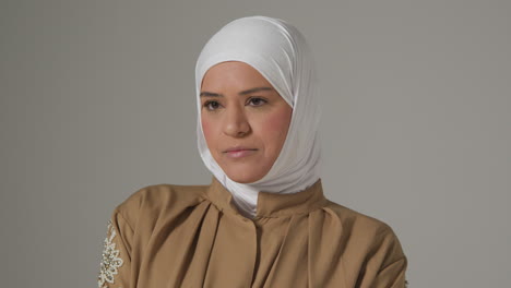 studio head and shoulders portrait of muslim woman wearing hijab